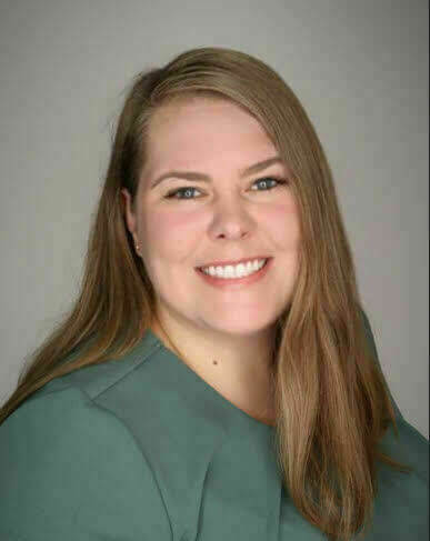 Headshot of Mara, presenting as a caucasian female with light brown hair and a teal blouse.