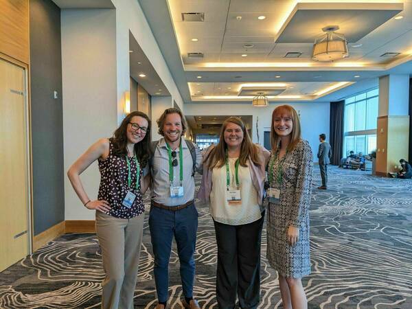 Lab members standing together in a conference hall.
Presented from left to right: Jamie, Harrison, Mara, and Veronica