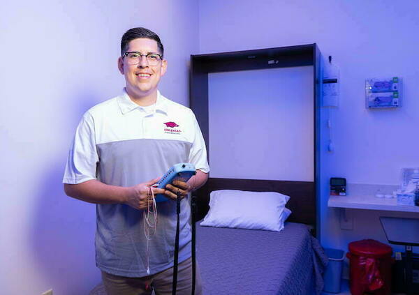 Dr. Vargas holding PSG equipment in a sleep study space