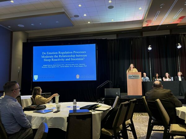 conference presentation with a cisgender white woman presenting at the annual behavioral sleep medicine conference.